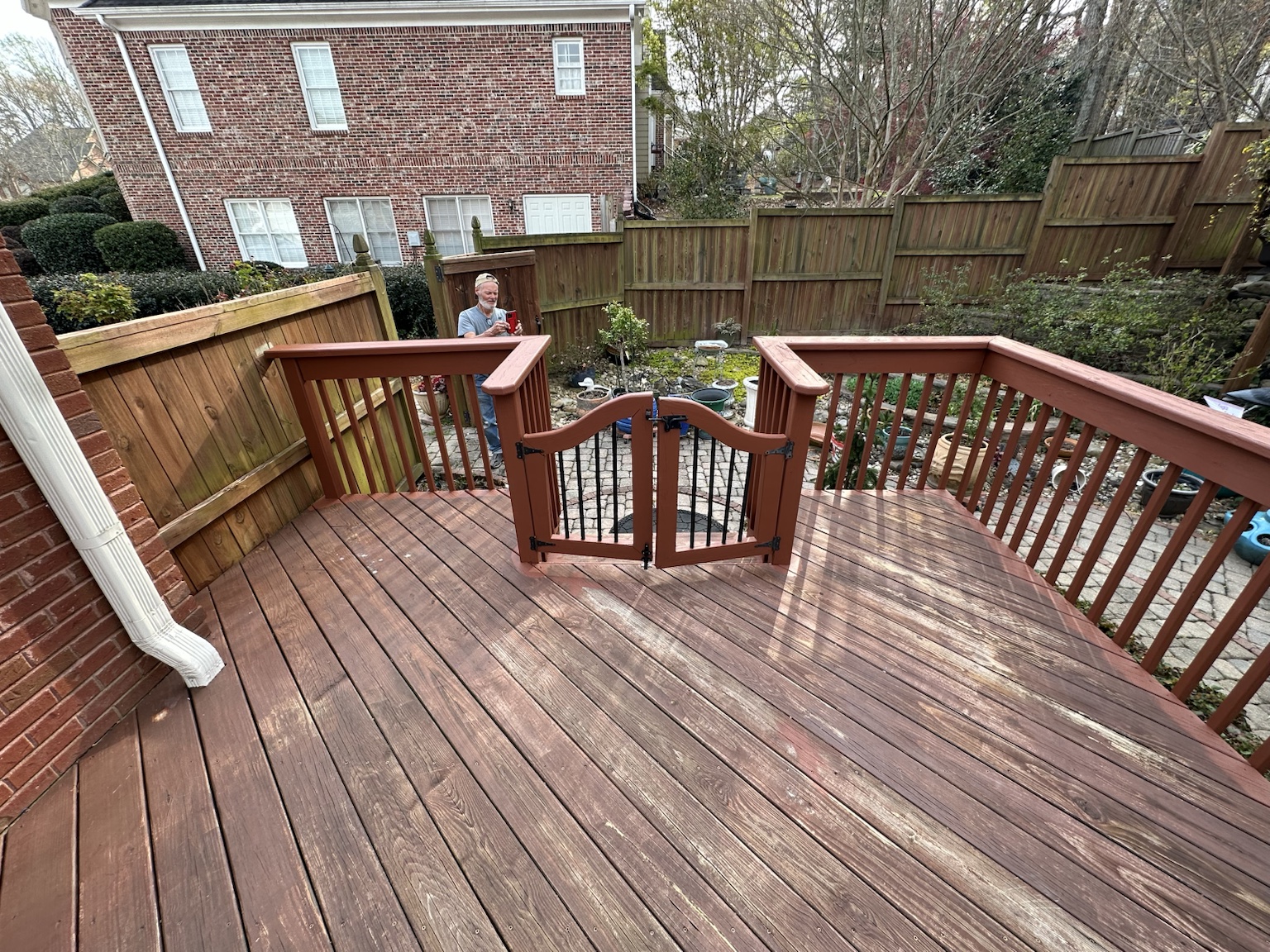 Residential deck and exterior before renovation — view 8
